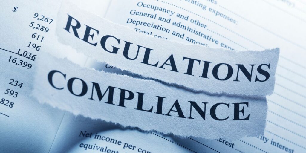 A book with two strips of paper, one labeled 'Regulations' and the other 'Compliance,' symbolizing regulatory compliance in forex trading.